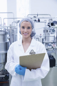 Portrait of smiling scientist holding a clipboard